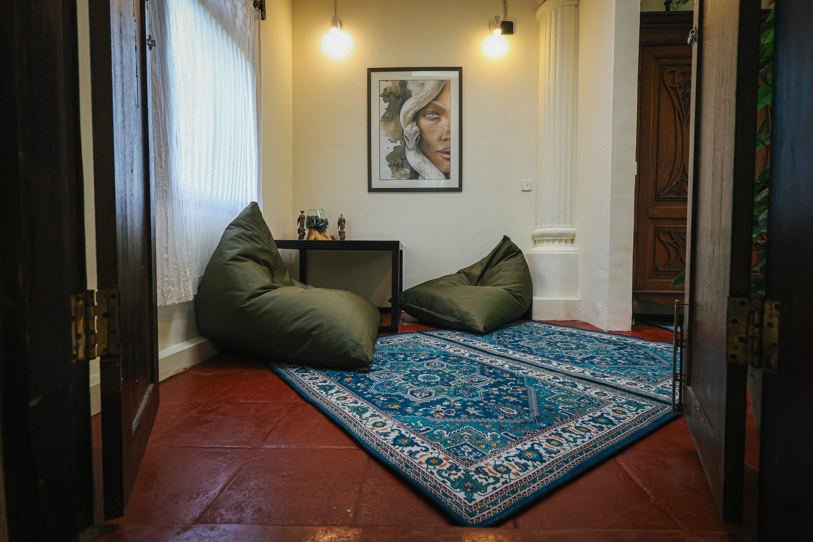 Living area of a castle room with rugs and columns